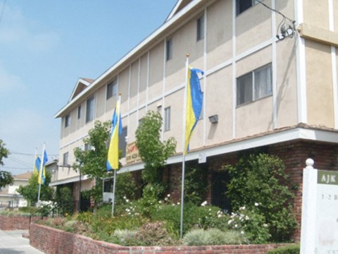 a large building with flags in front of it