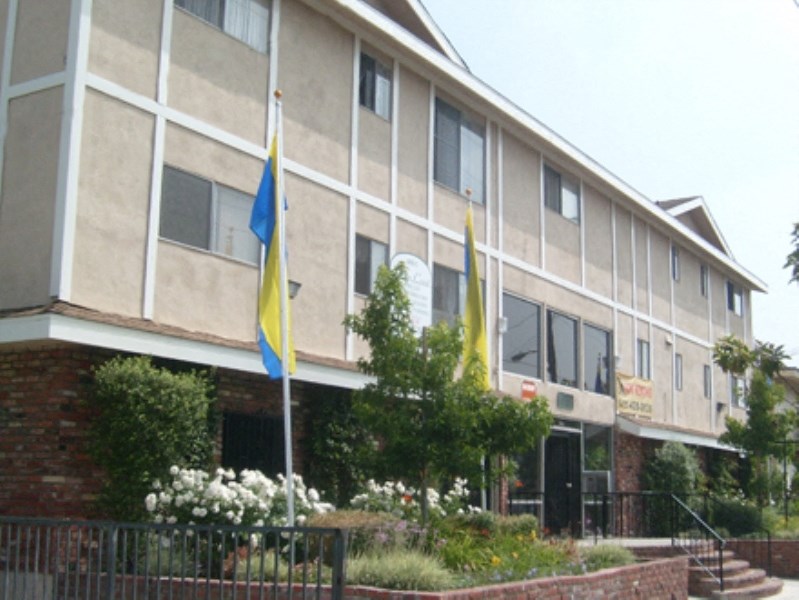a large building with flags in front of it