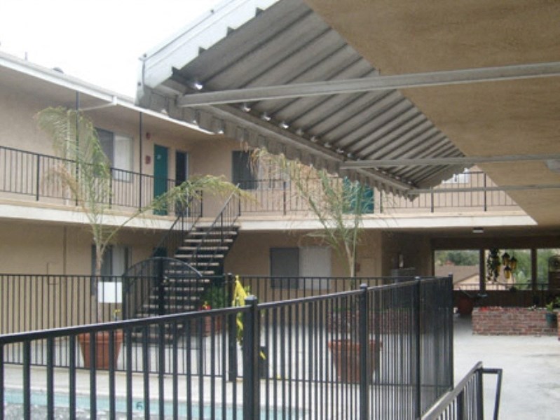 an apartment building with a balcony and a black fence