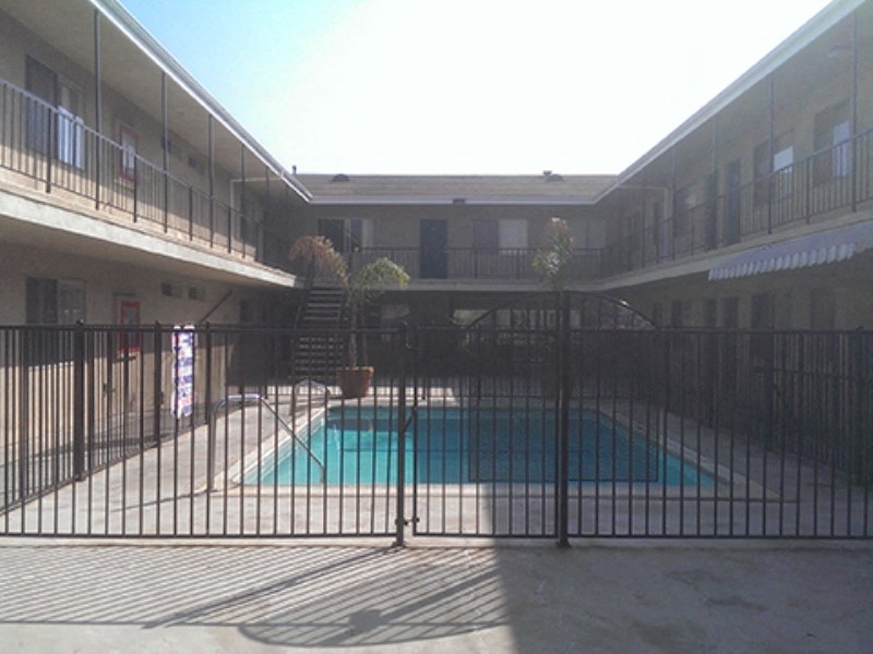 a view of the pool from behind a fence