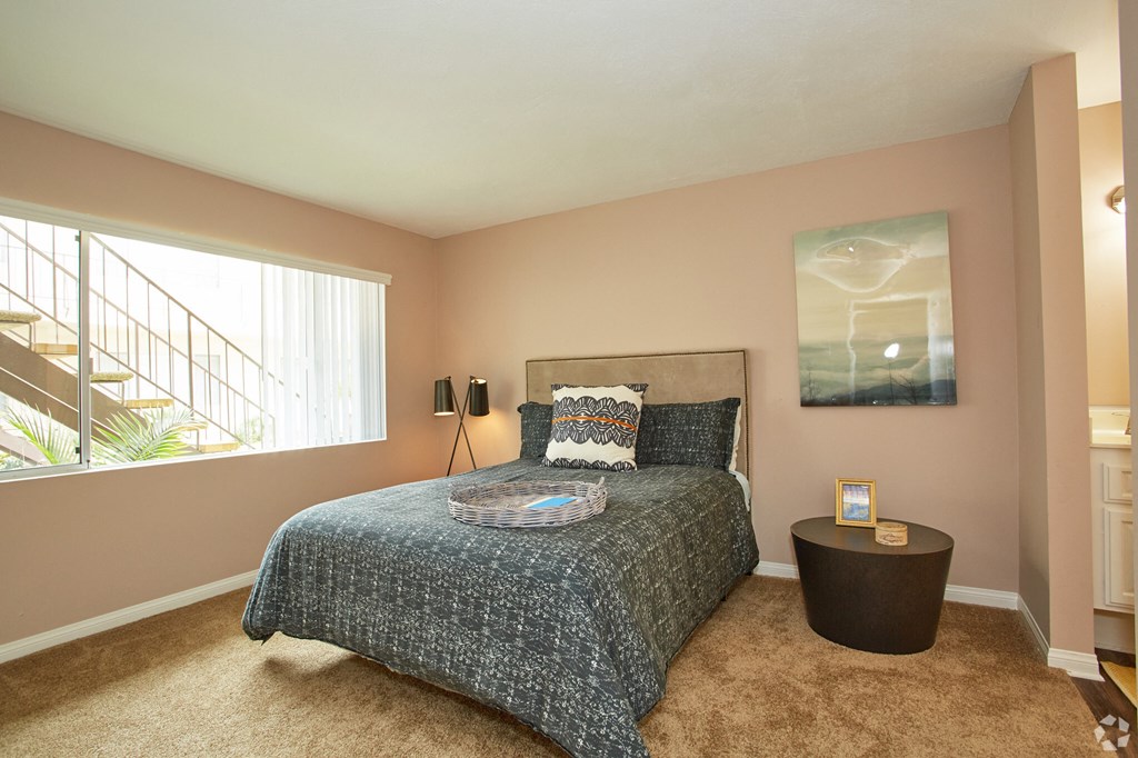 a bedroom with a bed and a window