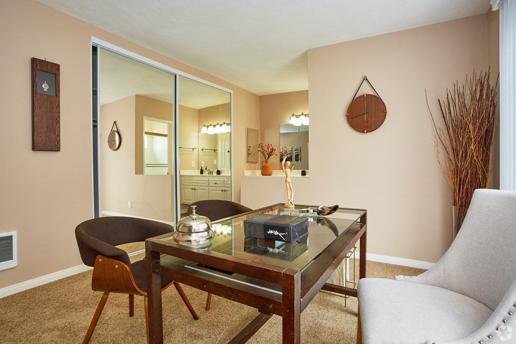 a living room with a glass table and two chairs