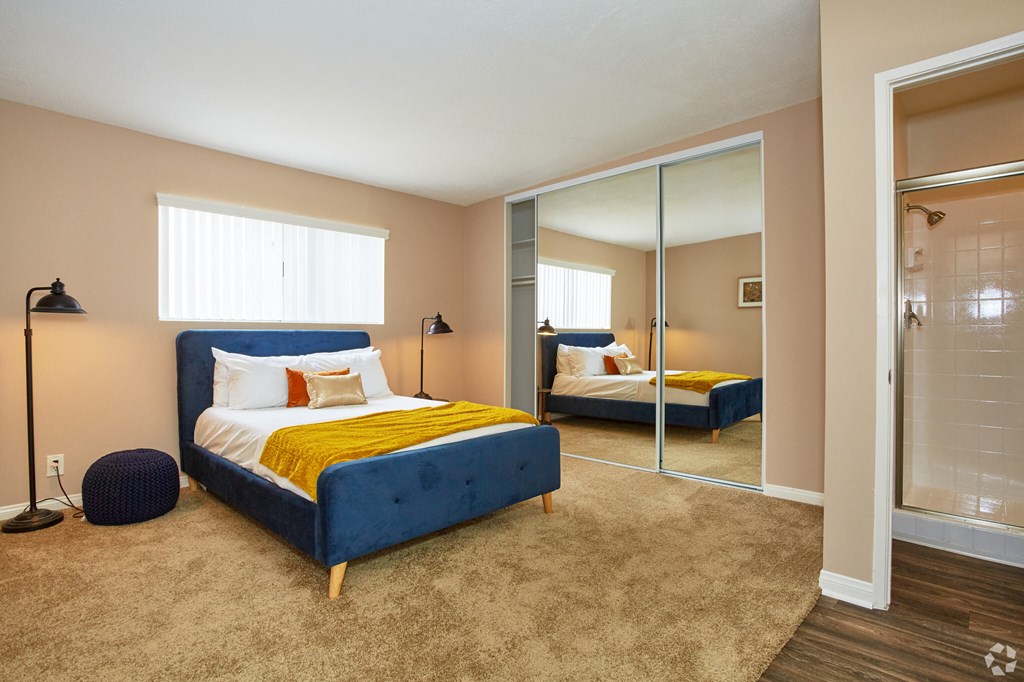 a bedroom with a bed and a mirror