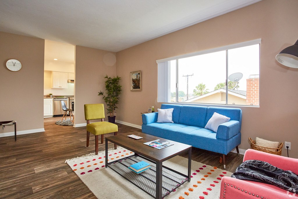 a living room with a blue couch and yellow chair