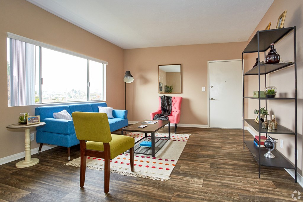 a living room with a blue couch and yellow chair