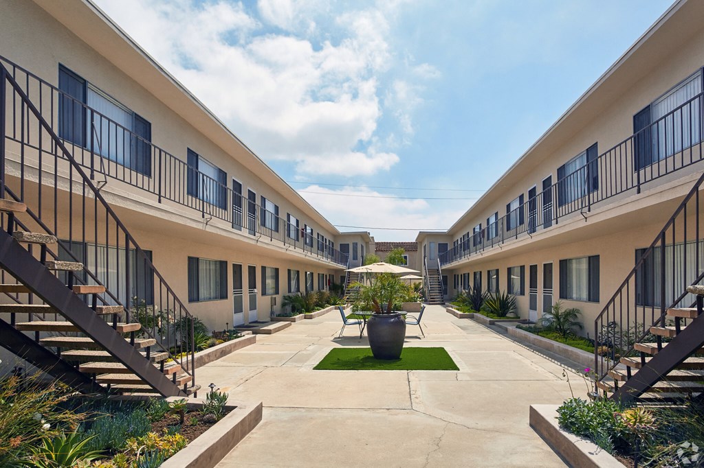 a courtyard with a large vase in the middle of it