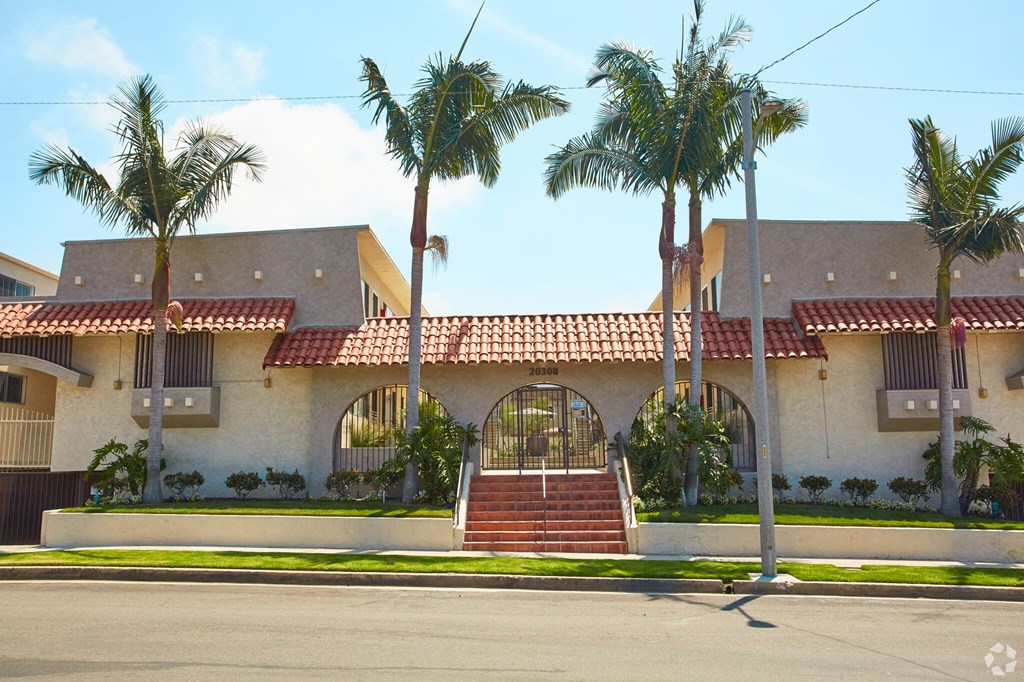 a house with palm trees in front of it