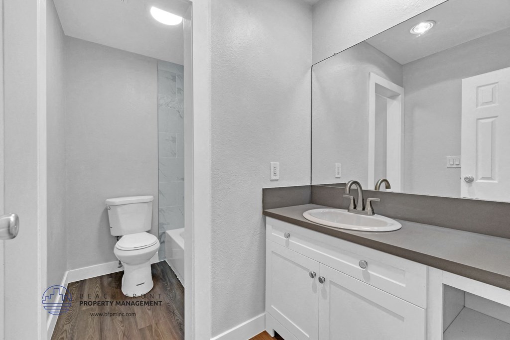 a bathroom with a sink toilet and a mirror