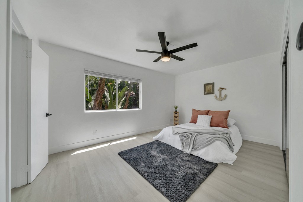 a room with a bed and a clock on the wall