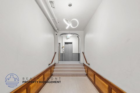 a stairway in a building with white walls and wooden stairs