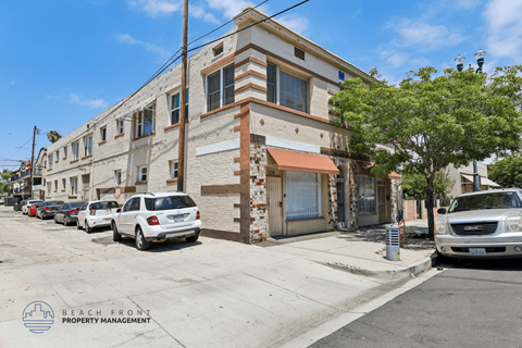 A street view of a building with a sign that reads "BEACH FRONT PROPERTY MANAGEMENT".