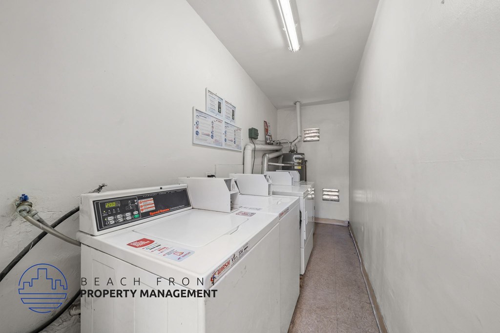 A white industrial room with a control panel and a sign that says Beach Front Property Management.