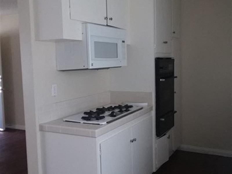 a small kitchen with a stove and a microwave