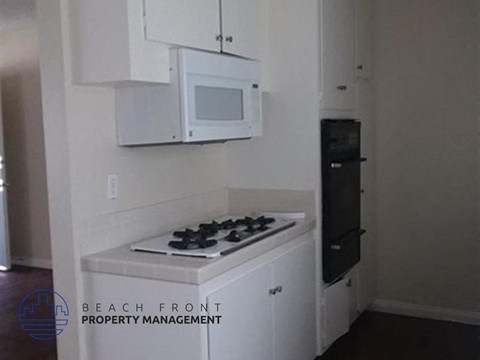 a small kitchen with a stove and a microwave