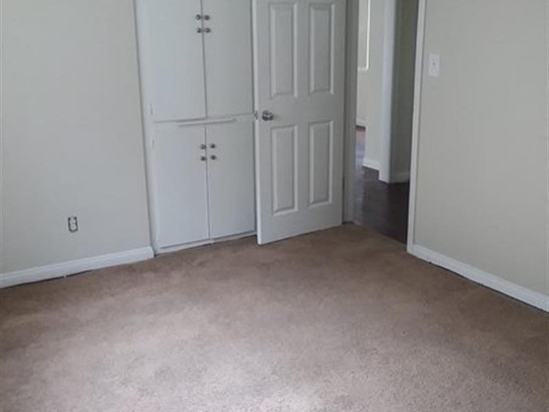 a room with a white door and a carpeted floor