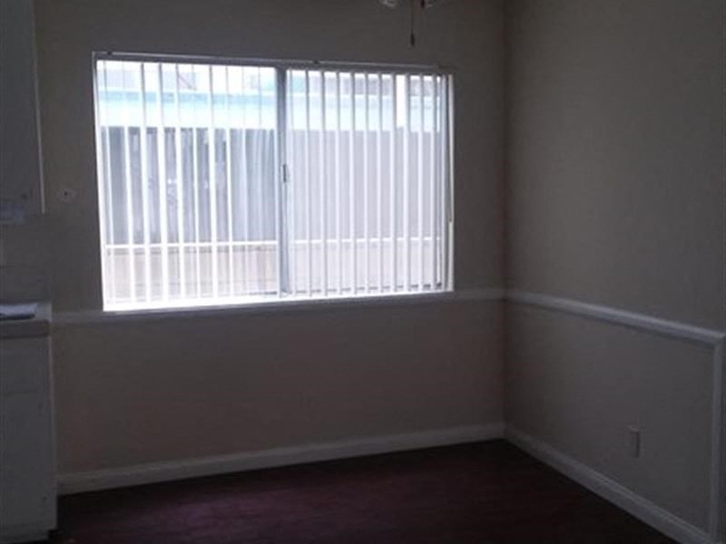 a small room with a window and a red carpet