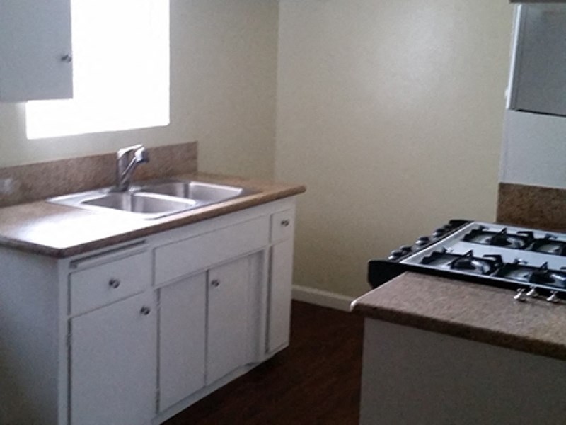 a kitchen with a sink and a stove