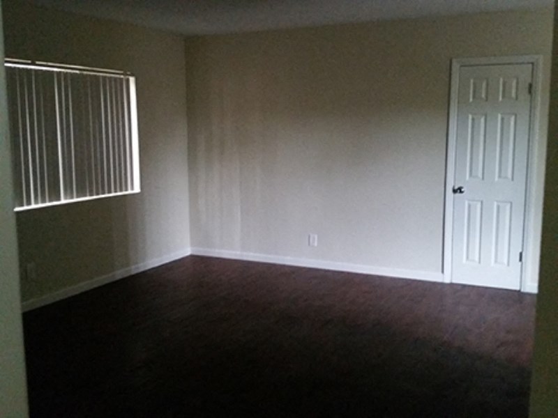 an empty room with a door and a window