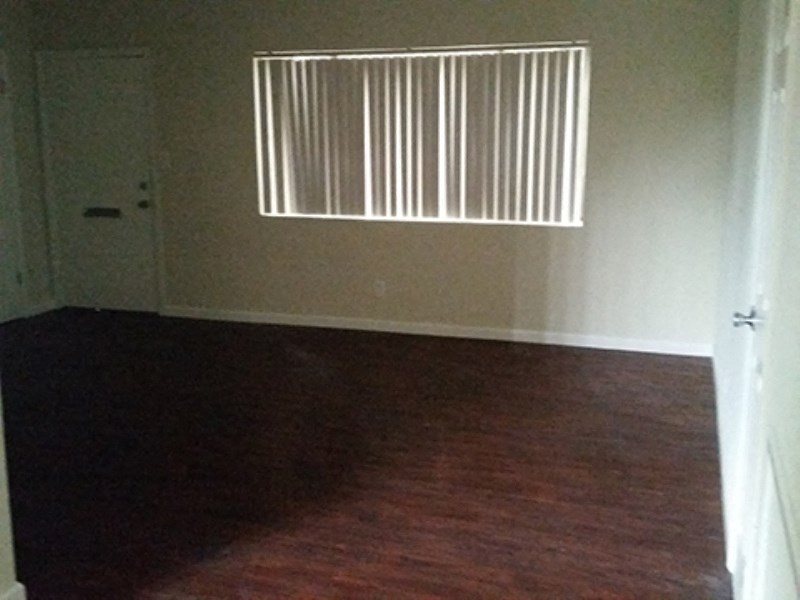 an empty room with a door and a window