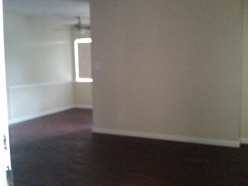 an empty room with a white wall and a white door