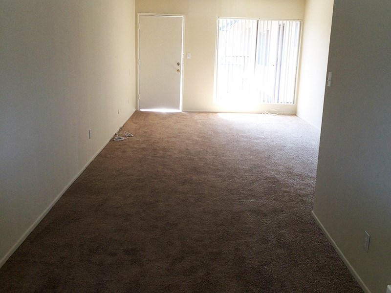 an empty room with a door that is open