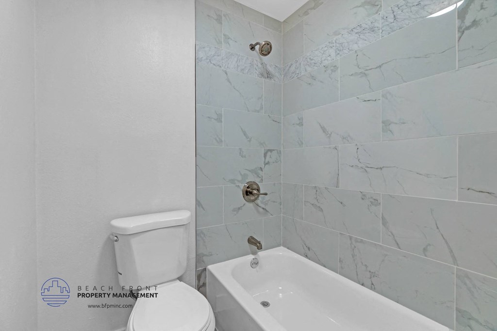 a bathroom with a tub and a toilet in it