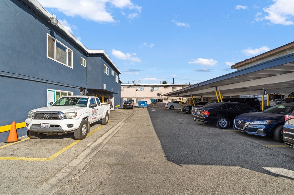a parking lot with cars parked in front of a building
