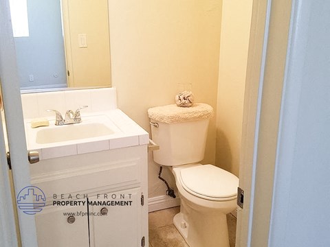 a bathroom with a toilet and a sink and a mirror