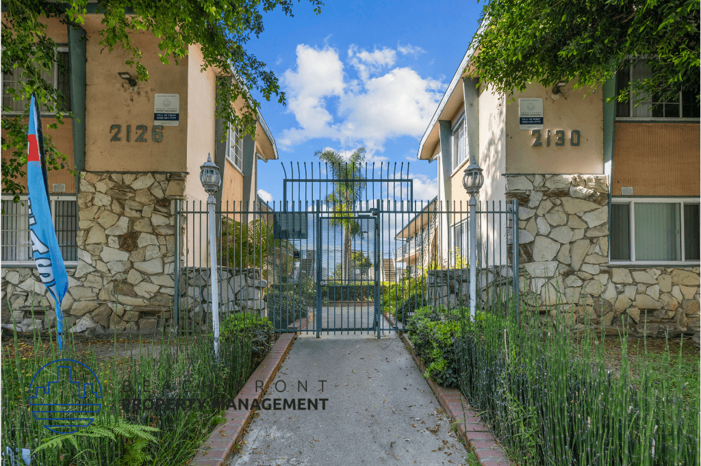 an empty pathway between two buildings with a gate