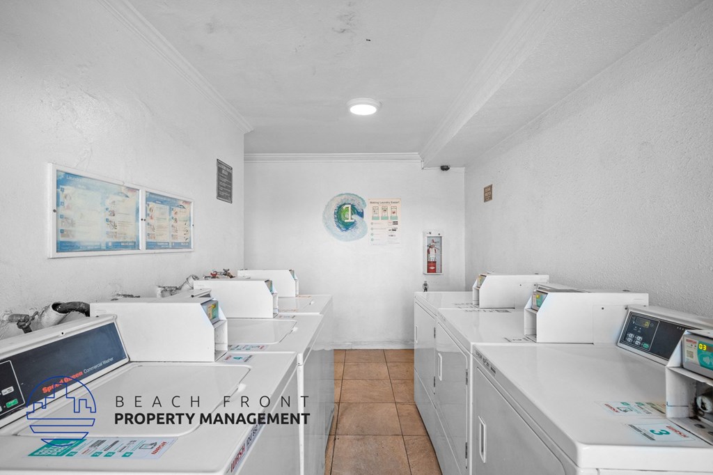 a beachfront property management office with washing machines and dryers
