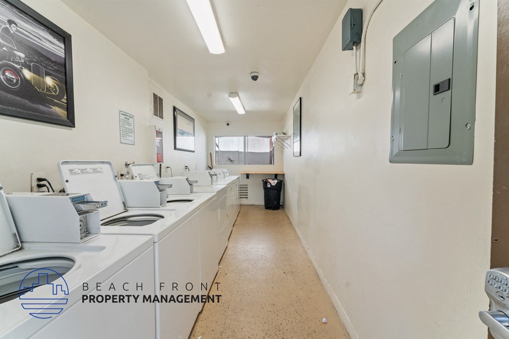 A clean, well-lit commercial kitchen with a logo for Beach Front Property Management.