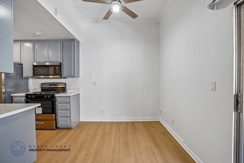 A kitchen with a stove top oven and microwave.