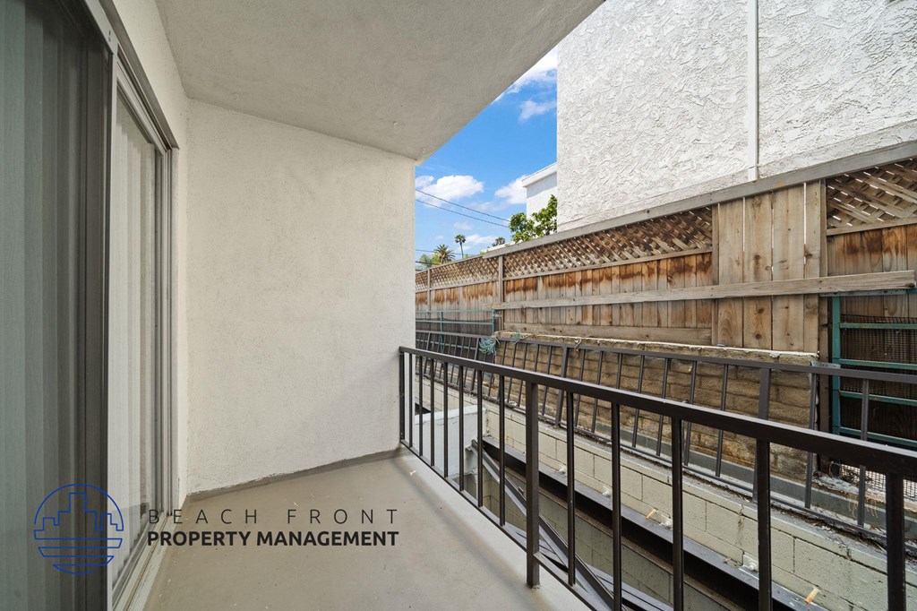 A balcony with a railing overlooking a construction site.