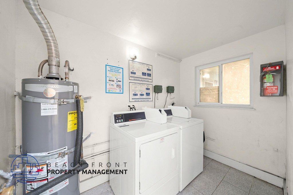 A room with a water heater and a tank.