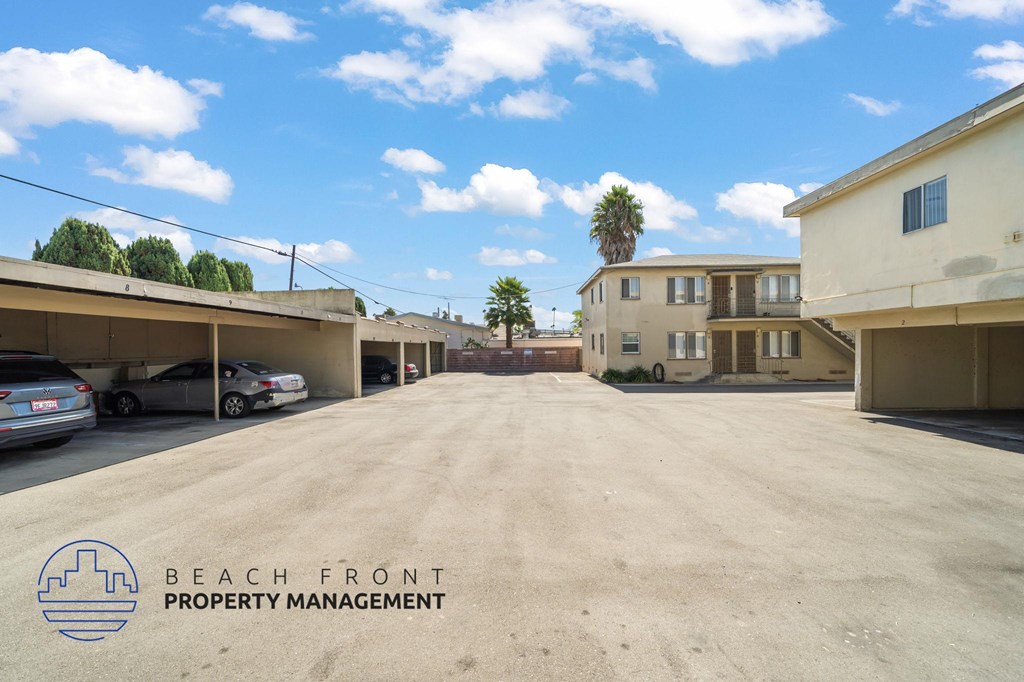 A parking lot with Beach Front Property Management logo.