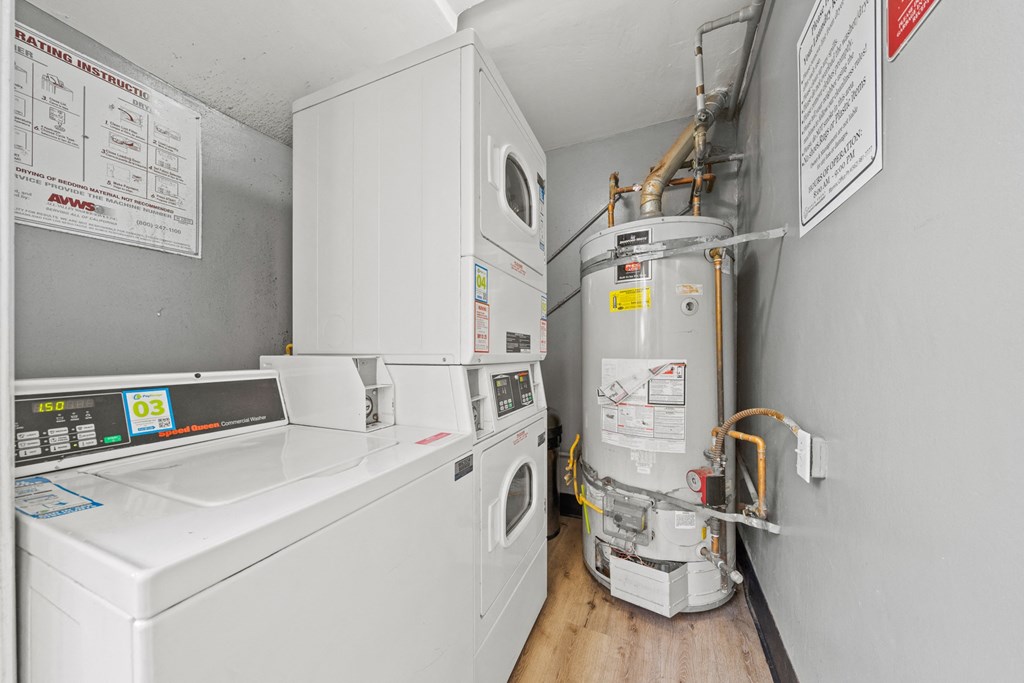 a kitchen with a washer and dryer and a stove and a refrigerator