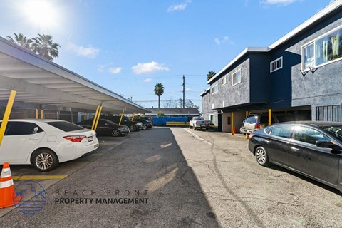 a parking lot with cars in front of a building