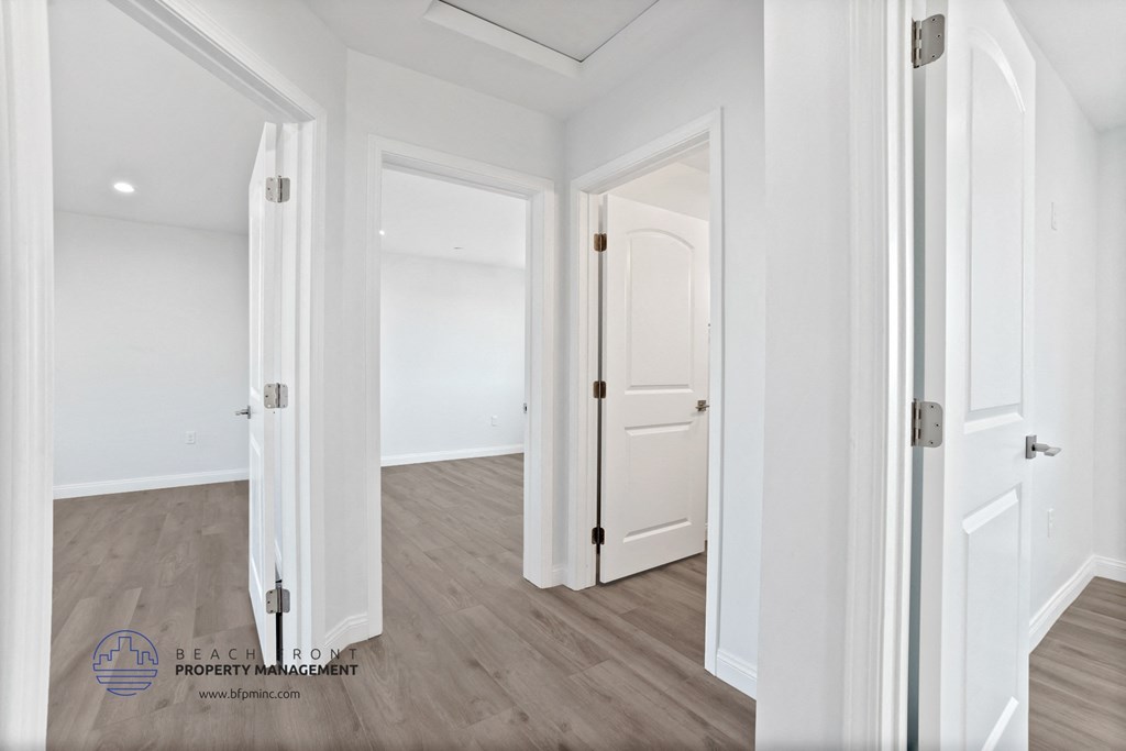 a renovated living room with white walls and white doors
