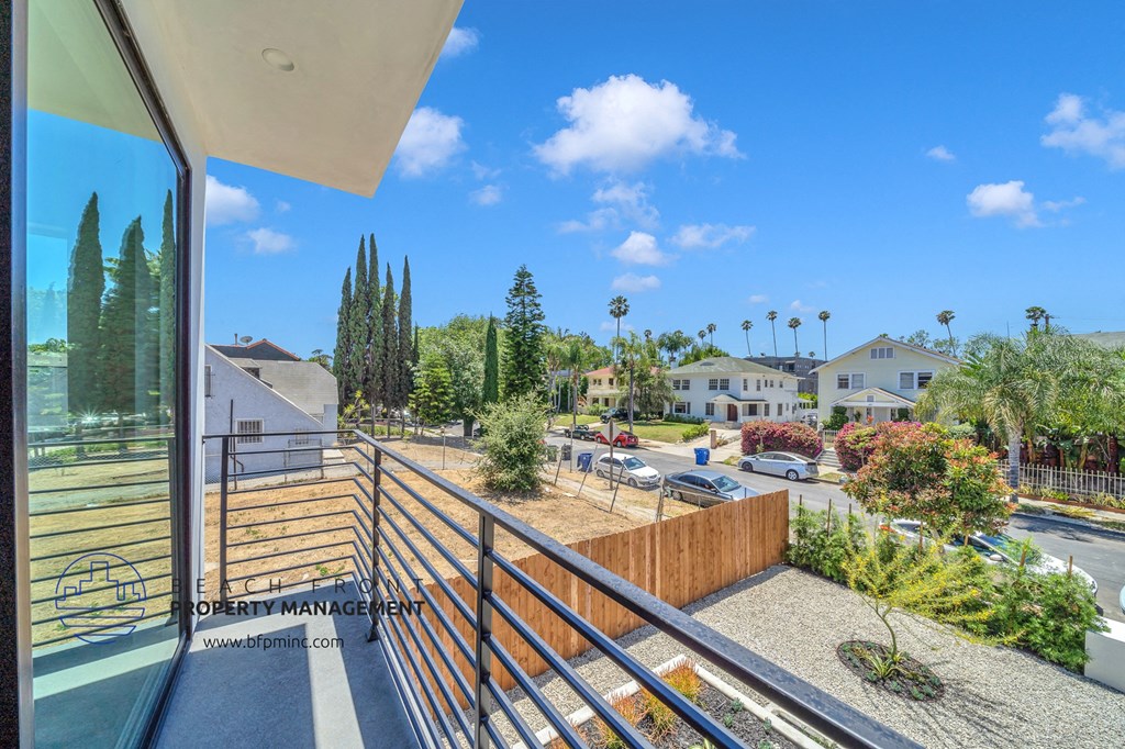 a balcony with a view of the street and some houses