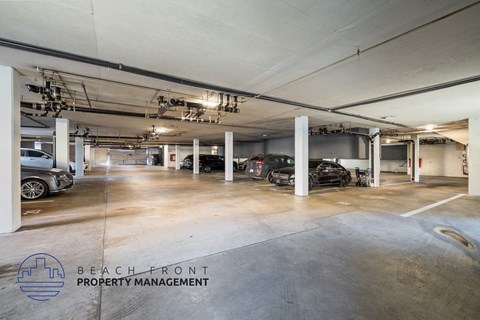 A spacious parking garage with multiple cars parked inside.