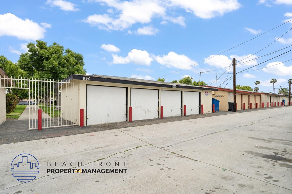 A row of garage doors with the logo Beach Front Property Management on the bottom left.