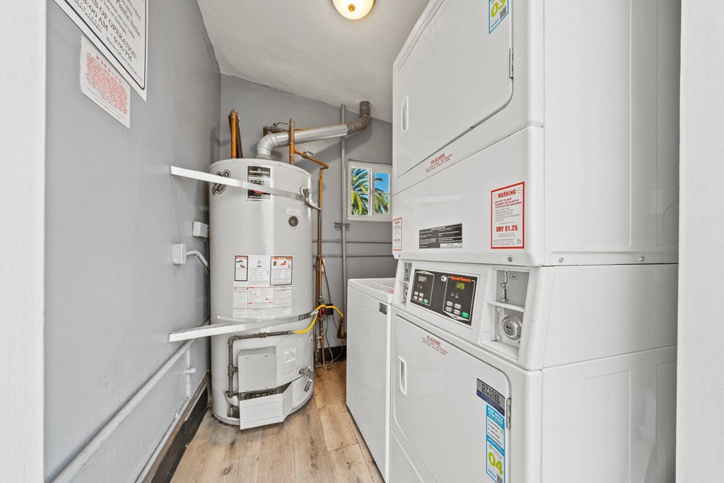 a small room with two refrigerators and a water heater