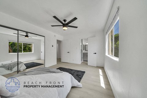 a bedroom with a bed and a ceiling fan