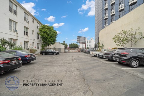 a parking lot with cars parked on the side of a building