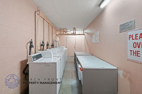 a laundry room with several washes and dryers in it