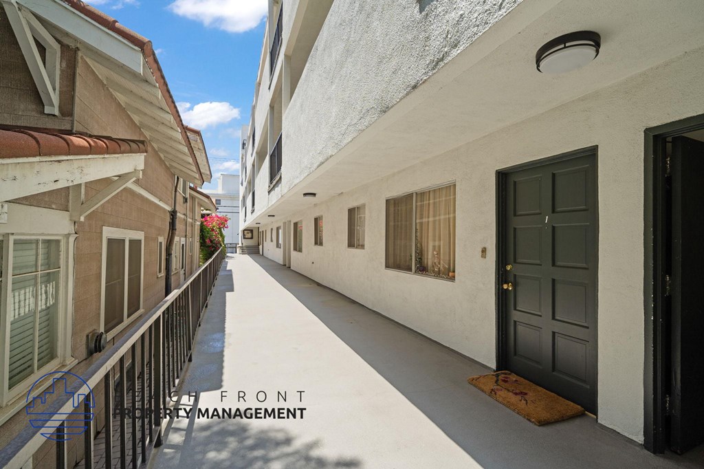 A narrow street with apartment buildings on either side.