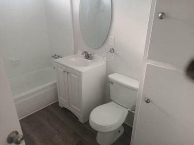 a bathroom with a toilet and a sink and a mirror