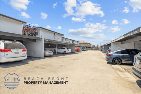a parking lot with cars parked on the side of a building