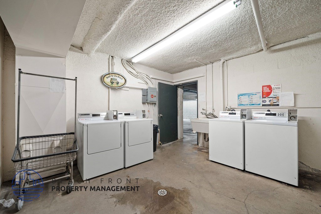 A room with white cabinets and a shopping cart in it.