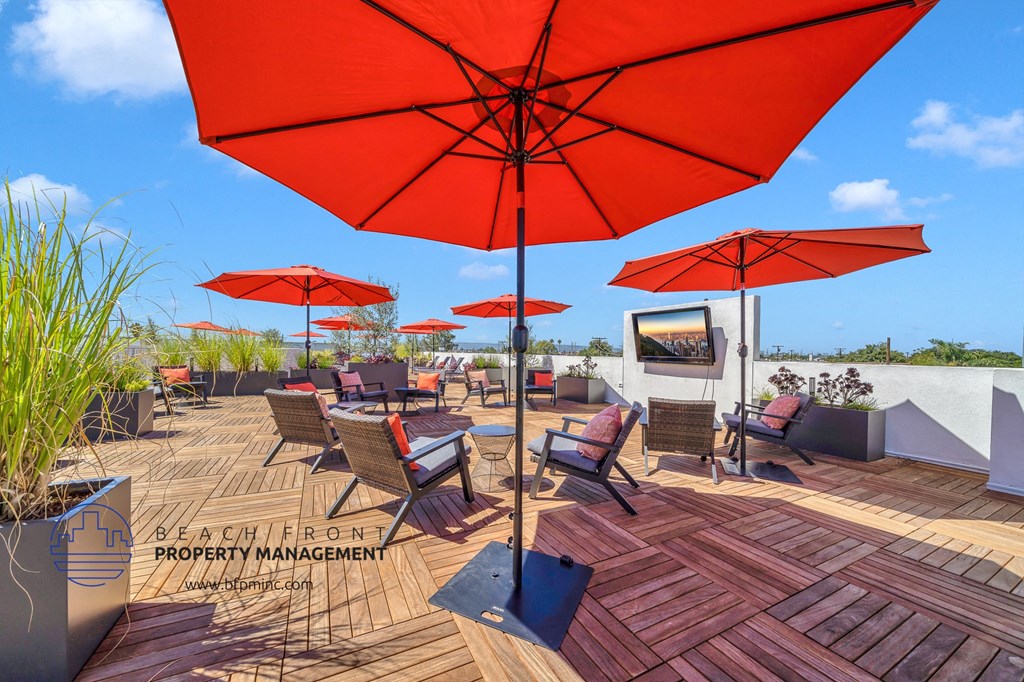 a patio with tables and umbrellas on a roof